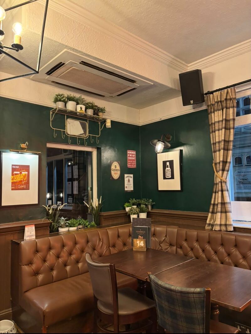 A snug corner at O'Farrell's with leather seating and plants under warm lighting